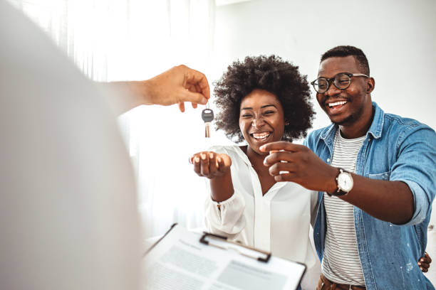 Young couple in love starting family life, got a chance of acquiring independent home ownership, given key from new apartment, social renting, purchasing new apartment, meeting with real estate agent